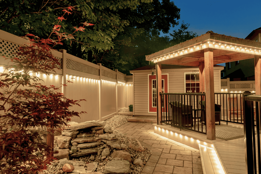 Permanent lighting in backyard, trim, and fence.