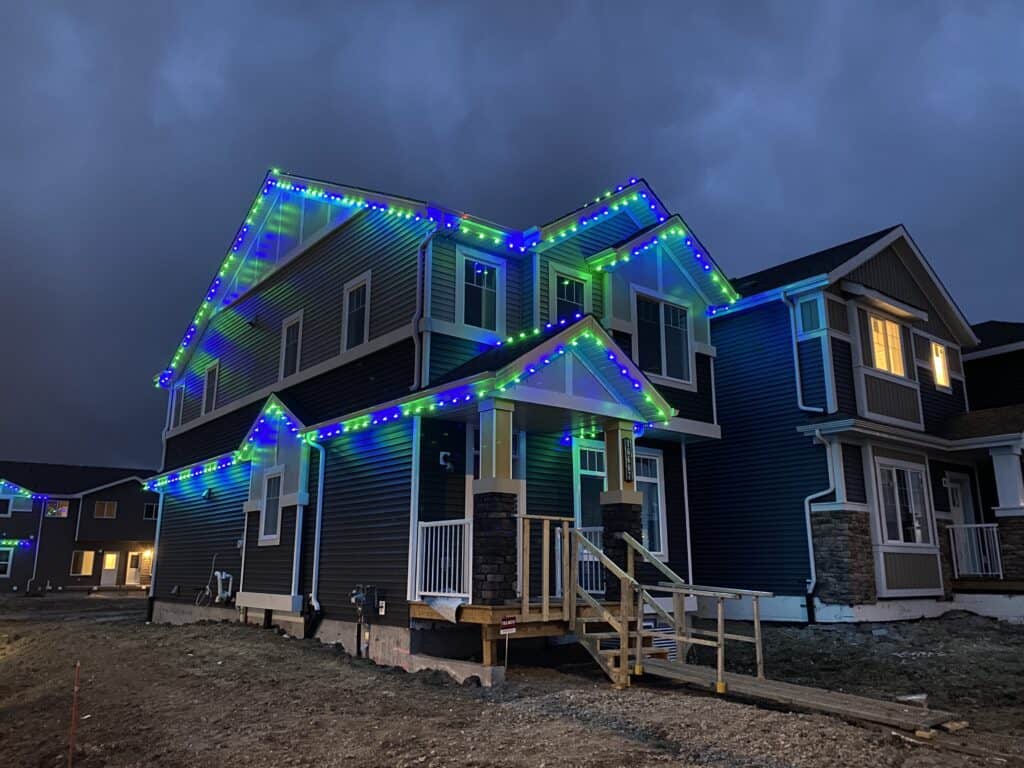 show home lit up with blue and green lights