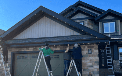 Christmas lights installation on a home with ladders