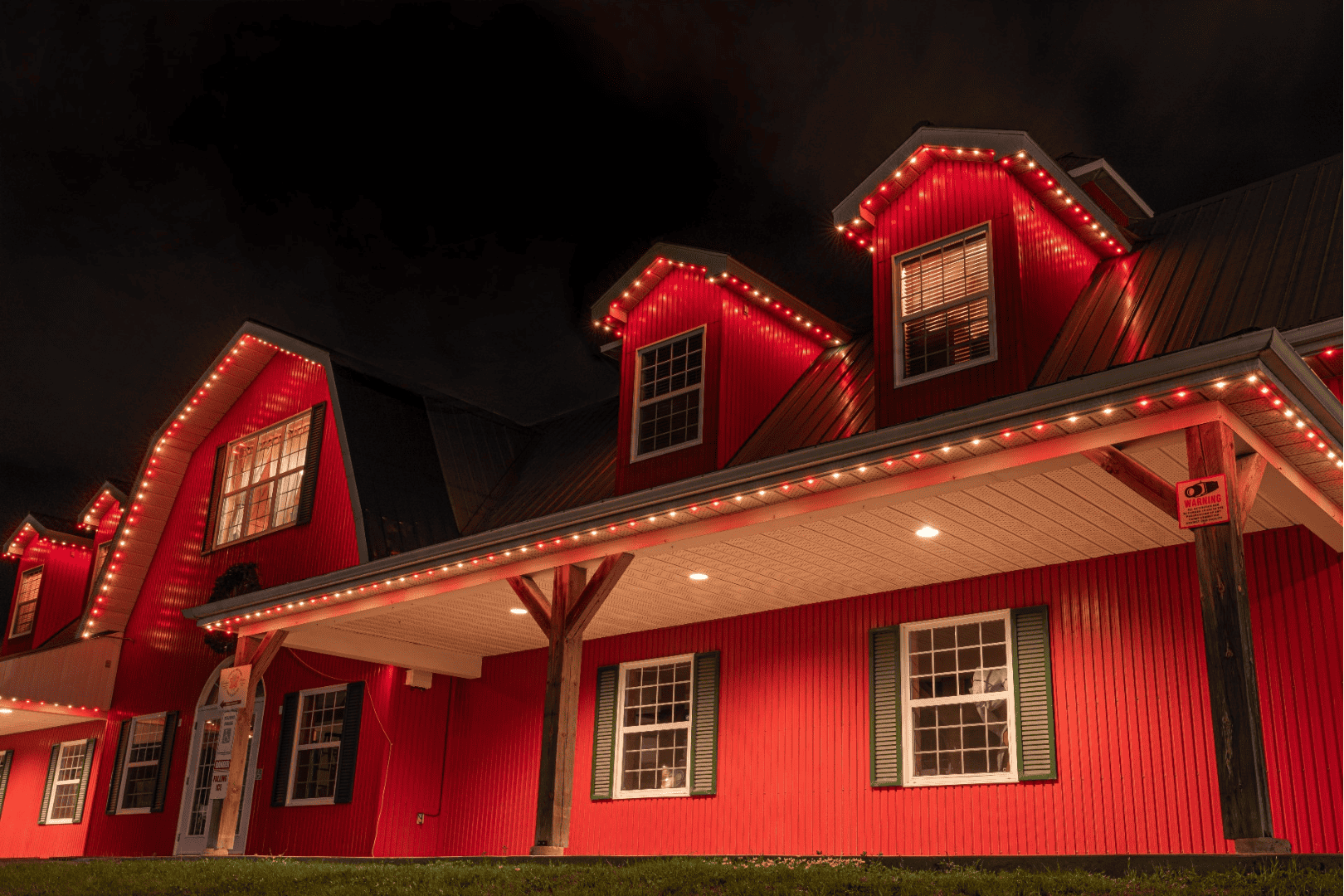 A red house with festive red lights for the holidays